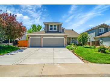 Charming two-story home with a well-maintained lawn and a spacious driveway leading to a two-car garage at 20530 Parker Vista Cir, Parker, CO 80138
