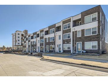 New townhome construction featuring brick exteriors, white trim, and modern design elements at 374 North Geneva, Aurora, CO 80010