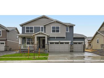Charming two-story home with a three car garage and a beautifully landscaped front yard at 4588 Thistle Dr, Brighton, CO 80601