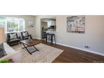 Bright living room with a decorative rug, stylish furniture, and a view into the modern kitchen at 500 S Pennsylvania St # 520, Denver, CO 80209
