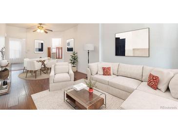 Bright living room with hardwood floors, comfortable seating, and a dining area at 561 Cherokee St, Denver, CO 80204