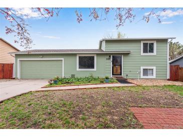 Charming two-story home with a well-maintained front yard and an attached garage, perfect for suburban living at 15628 E Girard Pl, Aurora, CO 80013