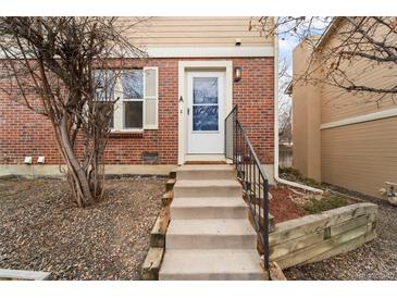 Inviting entrance with stairs leading to the front door of this brick townhome at 1545 S Ouray Cir # A, Aurora, CO 80017