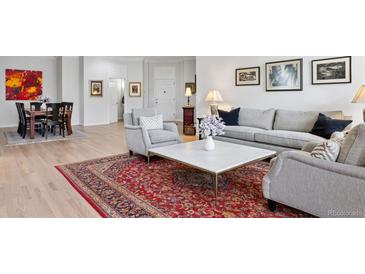 Bright living room features elegant decor, hardwood floors, and an inviting seating arrangement at 301 Garfield St # 1E, Denver, CO 80206