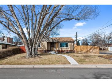 Charming ranch-style home with a large tree and a well-maintained front yard at 4499 E Colorado Ave, Denver, CO 80222