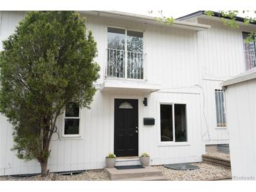 Charming two-story home with a striking black front door and well-maintained landscaping at 3073 W Center Ave # C, Denver, CO 80219