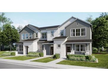 Charming townhome with modern farmhouse facade, attached garages, and inviting curb appeal at 6579 Parterre N Pkwy # 3, Thornton, CO 80602