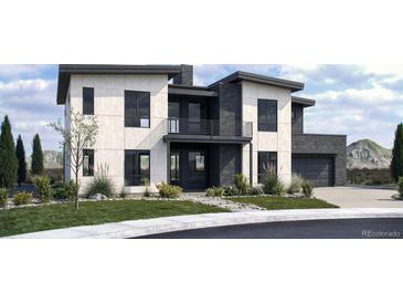 Modern two-story home featuring a balcony, dark framed windows, light colored siding, and lush landscaping at 5358 Lions Paw St, Castle Rock, CO 80104