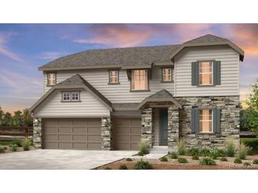 Charming two-story home featuring stone accents, a two-car garage, and professionally landscaped front yard at 5629 Farrier Pt, Castle Rock, CO 80104