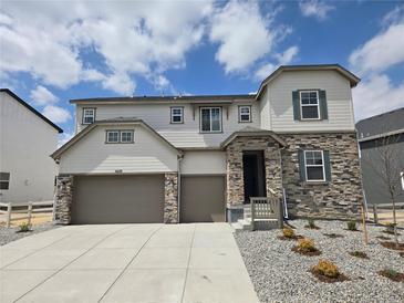 Charming two-story home with stone accents, a three-car garage, and professionally landscaped front yard at 5629 Farrier Pt, Castle Rock, CO 80104