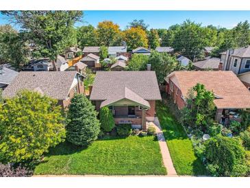 Charming home with a well-maintained front yard, mature trees, and inviting curb appeal at 2050 S Lincoln St, Denver, CO 80210