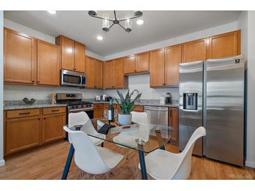 Well-equipped kitchen featuring stainless steel appliances, granite countertops, and a functional layout for cooking and entertaining at 1841 S Dunkirk St # 203, Aurora, CO 80017