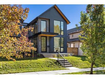 Modern two-story home with brick and dark siding, showcasing a sleek design at 410 S Vine St, Denver, CO 80209