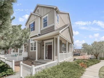 Inviting two-story home with a charming front porch and well-maintained landscaping at 1491 Ophir Rd, Castle Rock, CO 80109
