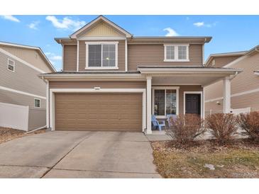 Charming two-story home featuring a covered porch, attached garage, and well-maintained landscaping at 20826 Robins Dr, Denver, CO 80249