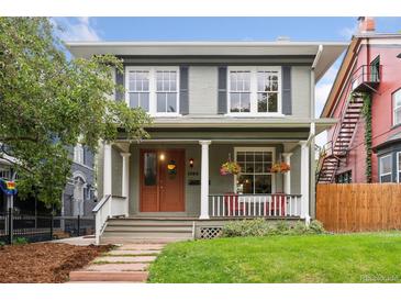 Charming home featuring a welcoming front porch, well-maintained lawn, and traditional architectural details at 1352 N Downing St, Denver, CO 80218