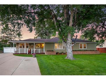 Charming ranch home with mature landscaping and a spacious lawn at 5450 Flower Ct, Arvada, CO 80002