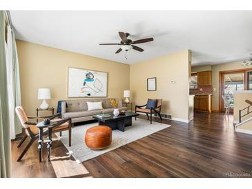 Inviting living room featuring hardwood floors, ceiling fan, and contemporary decor at 845 S Kenton St, Aurora, CO 80012
