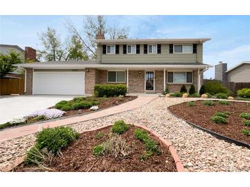 Charming two-story home with brick exterior, well-maintained landscaping, and inviting walkway at 13235 Rigel Dr, Lone Tree, CO 80124