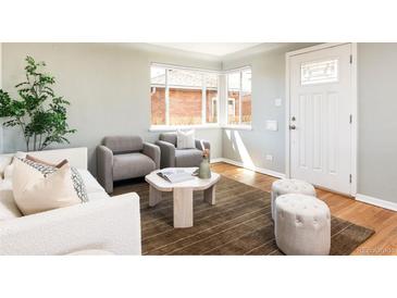 Bright living room with hardwood floors and natural light, creating a warm and inviting atmosphere at 3216 N Saint Paul St, Denver, CO 80205