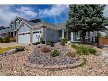 Charming home with a well-manicured front yard and two-car garage at 10132 Nickolas Ave, Highlands Ranch, CO 80130