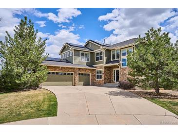 Beautiful two-story home features a stone and siding exterior, a three-car garage, and well-maintained landscaping at 282 N De Gaulle St, Aurora, CO 80018