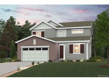 Charming two-story home featuring brick and siding, a two-car garage, and well-manicured lawn at 1361 Loraine N Cir, Erie, CO 80026