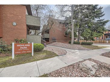 Brick multi-Gathering building with a Highland Park sign, trees, and landscaping at 3050 W 32Nd Ave # 102C, Denver, CO 80211