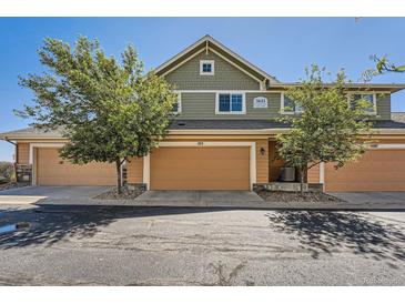 Charming townhome featuring a two-car garage and well-maintained landscaping at 3611 S Perth Cir # 103, Aurora, CO 80013