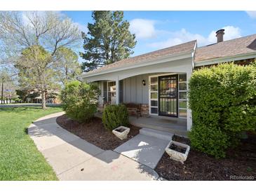 Charming home with welcoming porch and well-maintained landscaping at 2608 E Fremont Pl, Centennial, CO 80122