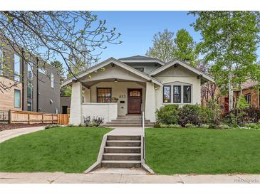 Charming bungalow with inviting front porch and well-manicured lawn at 853 Saint Paul St, Denver, CO 80206