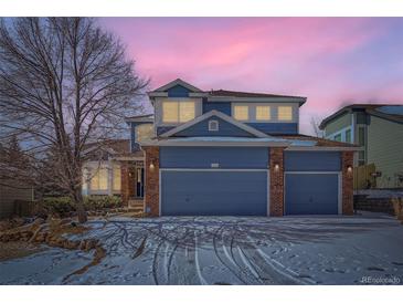Charming two-story home with a three-car garage and a beautiful blue exterior at dusk at 2105 Keota Ln, Superior, CO 80027