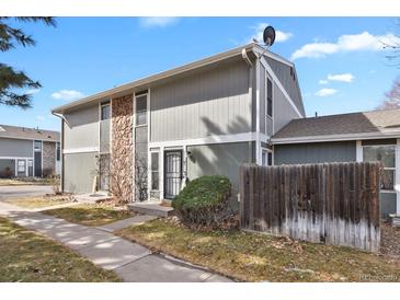 Two-story home featuring stone accents, neutral siding, and a well-kept lawn and walkway at 10001 E Evans Ave # 58B, Aurora, CO 80247