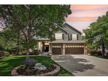 Charming two-story home with a three-car garage, mature landscaping, and a basketball hoop at 5046 Sage Brush Dr, Broomfield, CO 80023