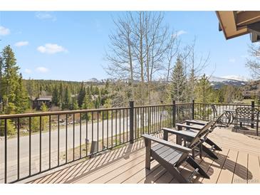 Mountain view from deck with outdoor furniture overlooking green trees at 100 River Park Dr # A, Breckenridge, CO 80424