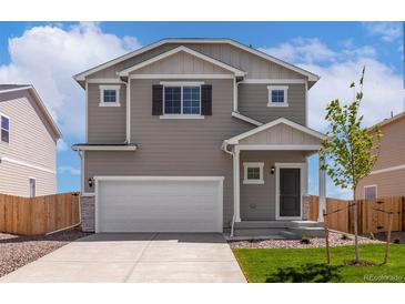 Charming two-story home with a two-car garage and a well-maintained front lawn and beautiful curb appeal at 48250 Shetland Dr, Bennett, CO 80102