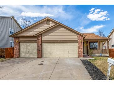 Charming home featuring a well-manicured lawn, front porch, and a convenient two-car garage at 965 W 96Th Ave, Thornton, CO 80260