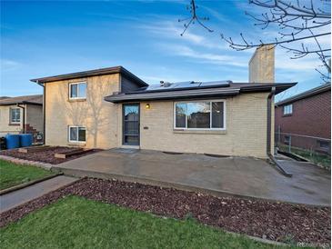 Charming home featuring a brick exterior, a cozy porch, and well-maintained landscaping, adding curb appeal at 3530 Dahlia St, Denver, CO 80207