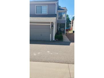 Charming two-story townhome with a gray garage and well-maintained landscaping, located in a desirable community at 12592 E Cornell Cir, Aurora, CO 80014