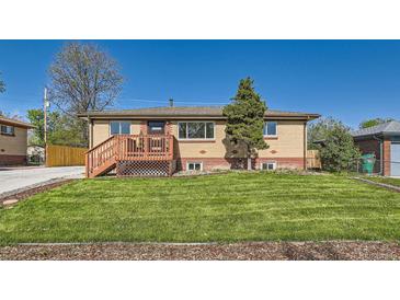 Charming single-story brick home with a cozy front porch and well-manicured lawn at 3871 Moore St, Wheat Ridge, CO 80033