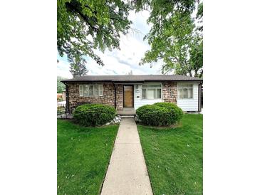 Charming single-story home featuring a stone facade and well-manicured front yard at 3231 S Galapago St, Englewood, CO 80110