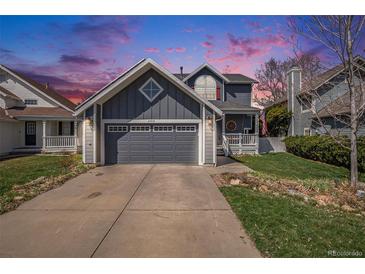 Charming two-story home featuring a two-car garage and inviting front porch at 21710 Silver Meadow Ln, Parker, CO 80138