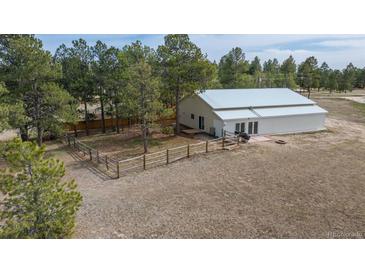Charming single-Gathering home on a sprawling lot with a metal roof, a fenced in garden, and an outbuilding at 37677 Sable Ridge Rd, Elizabeth, CO 80107