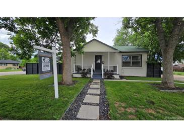Charming single-story home with a well-maintained front yard and inviting walkway at 6005 E Iowa Ave, Denver, CO 80224