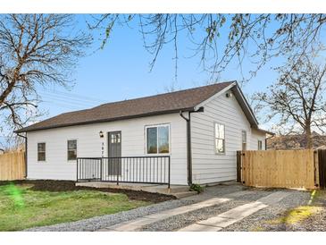 Charming home with a well-maintained lawn, dark trim, and a cozy front porch at 3073 S Elati St, Englewood, CO 80110