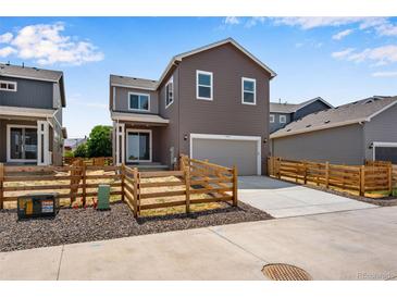 Charming two-story home featuring a modern design, neutral colors, and well-maintained landscaping at 17831 Parkside N Dr, Commerce City, CO 80022