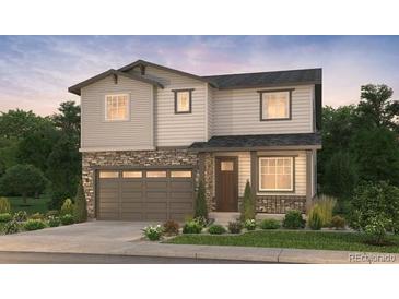 Charming two-story home featuring stone accents, a two-car garage, and manicured landscaping at 2165 S Ider Way, Aurora, CO 80018