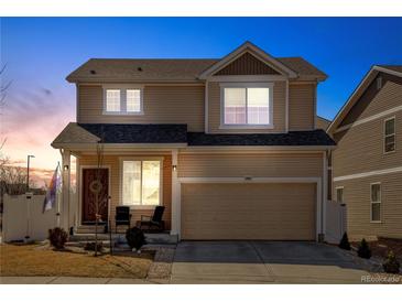 Charming two-story home featuring a well-maintained lawn and a two-car garage at 21088 Randolph Pl, Denver, CO 80249