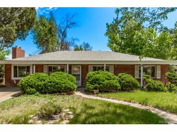 Charming single-story brick home with mature trees and a well-maintained front yard on a sunny day at 1000 Salem St, Aurora, CO 80011