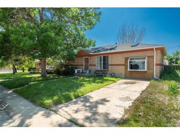 Charming brick ranch home with a well-maintained front yard and long driveway at 10839 Carrol Ln, Northglenn, CO 80233